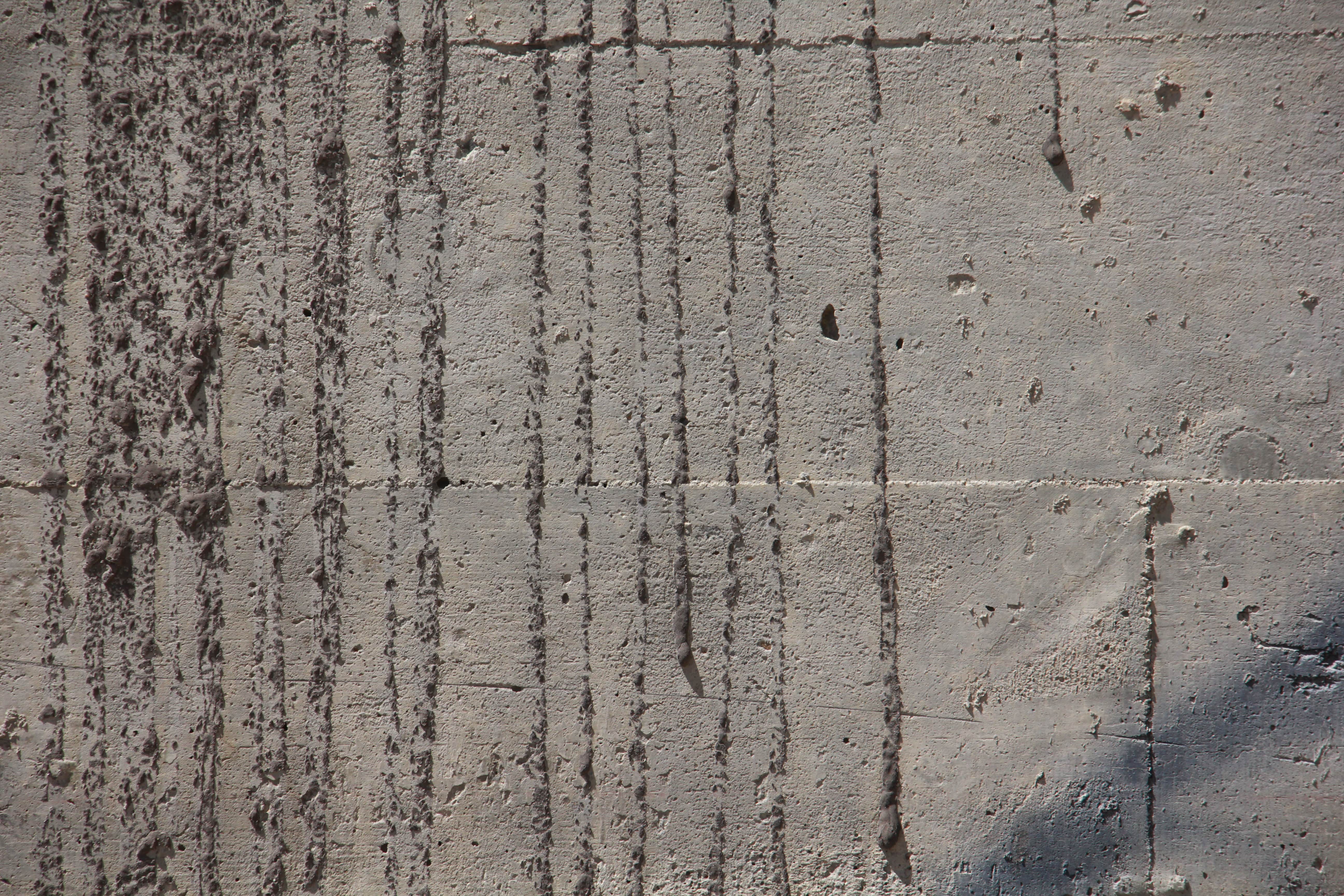 Stone Wall With Gray Bricks With Black Vertical Drops